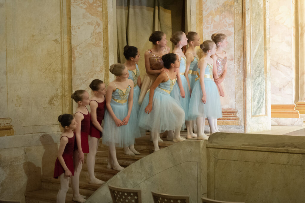 Little girls backstage on the stairs